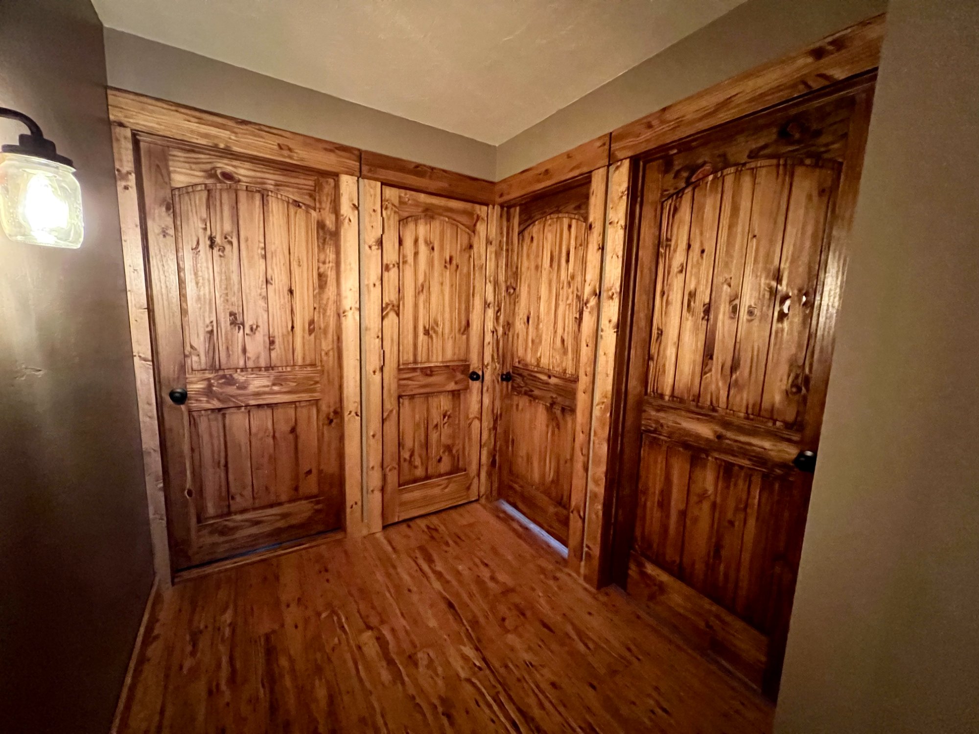 Beautifully stained knotty pine doors and hardwood floors in Manitowoc home