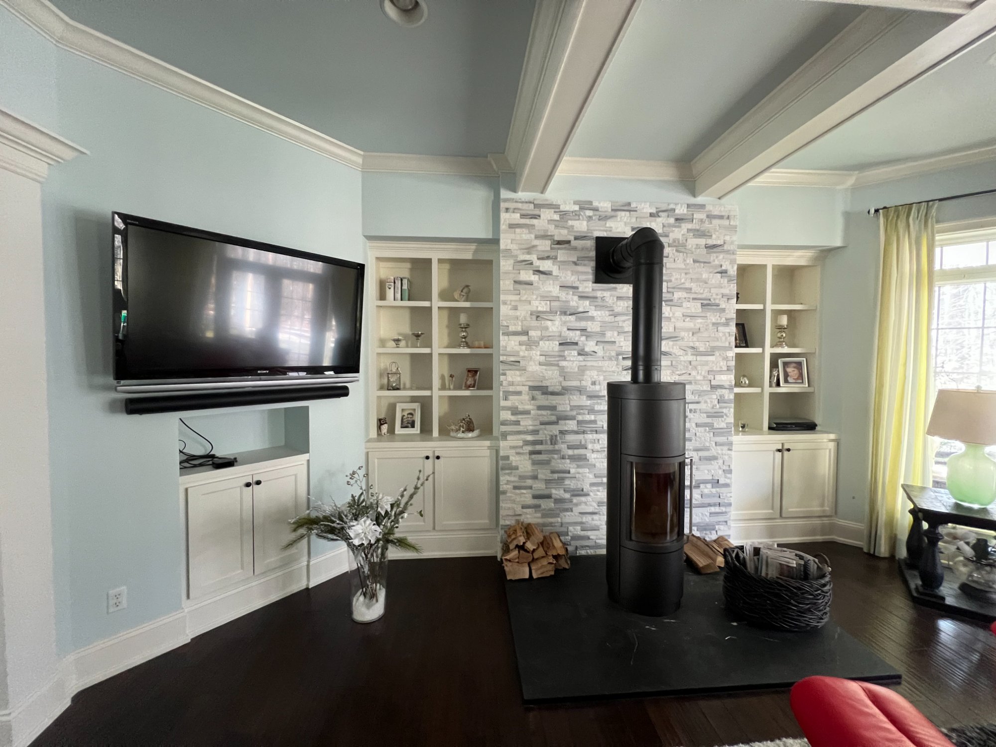 White painted built-in cabinets and shelving with stone fireplace surround in Manitowoc home