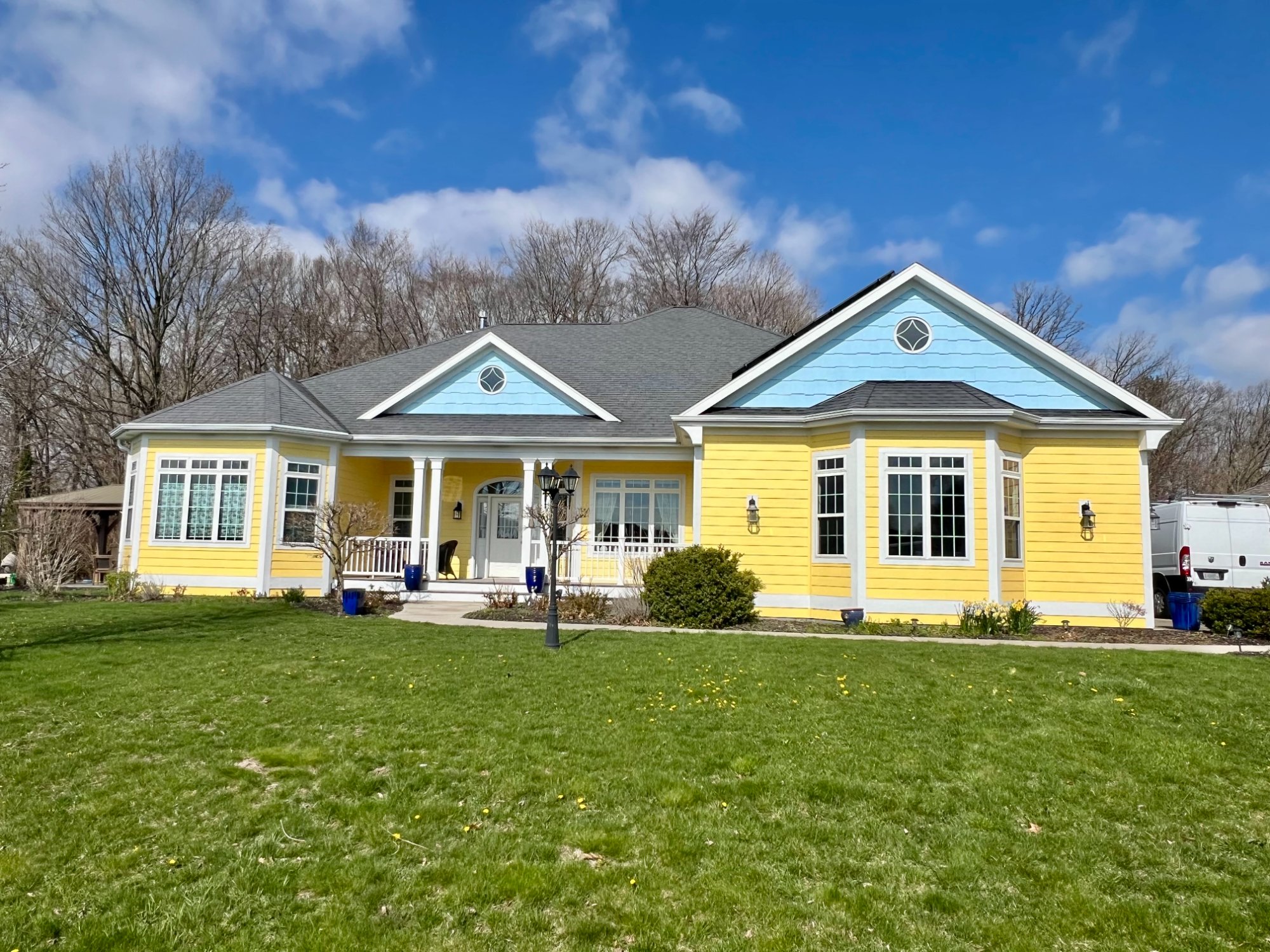 Yellow ranch home third angle showing full porch with white columns